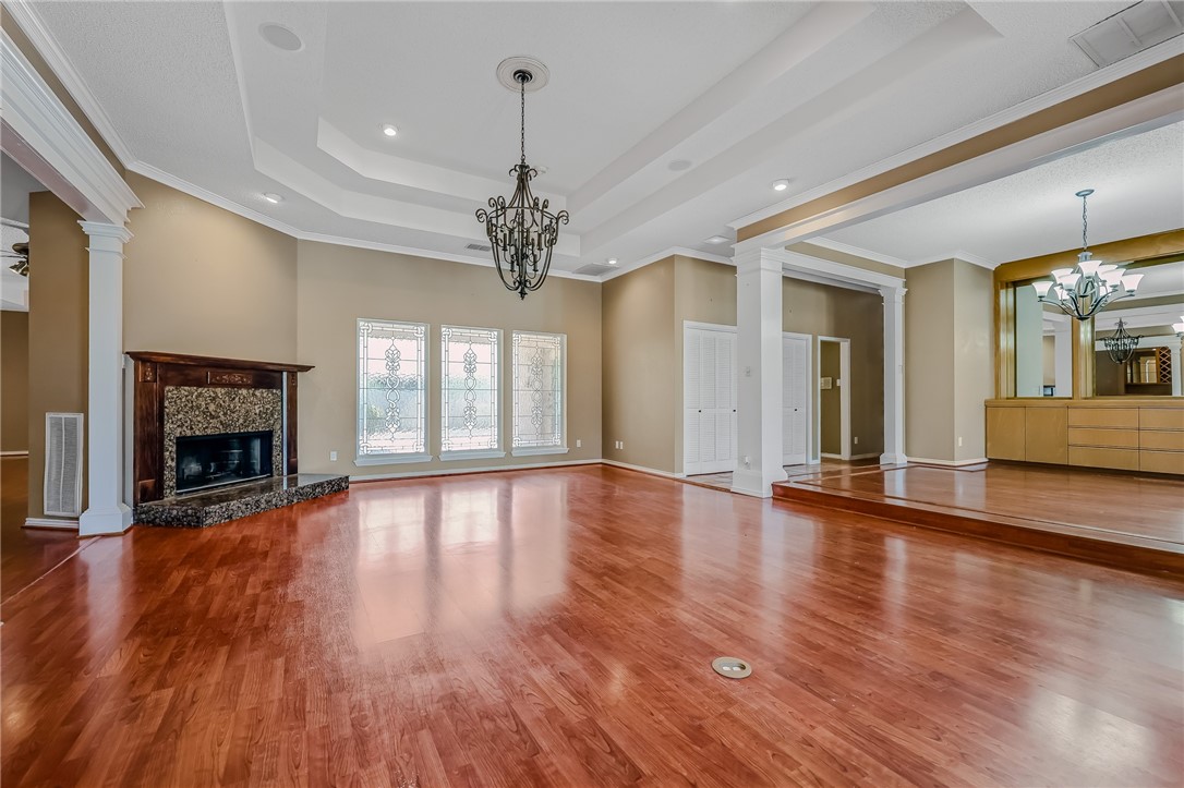 5917 Harvest Hill Road Corpus Christi, TX 78414 - Photo 6 of 40 a view of an empty room with wooden floor fireplace and a window