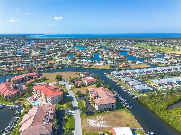 an aerial view of a houses with a lake view