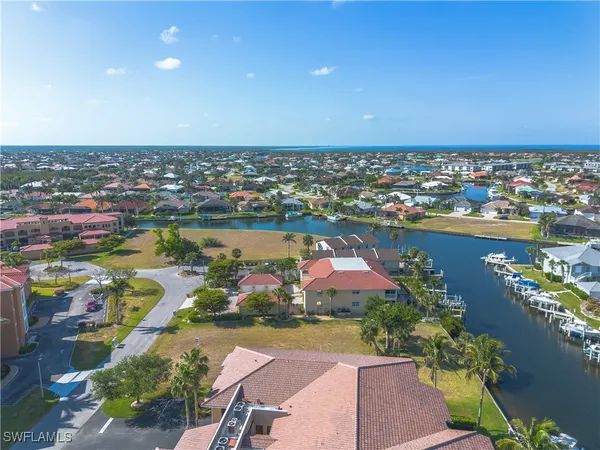 a aerial view of a house with a garden and lake view
