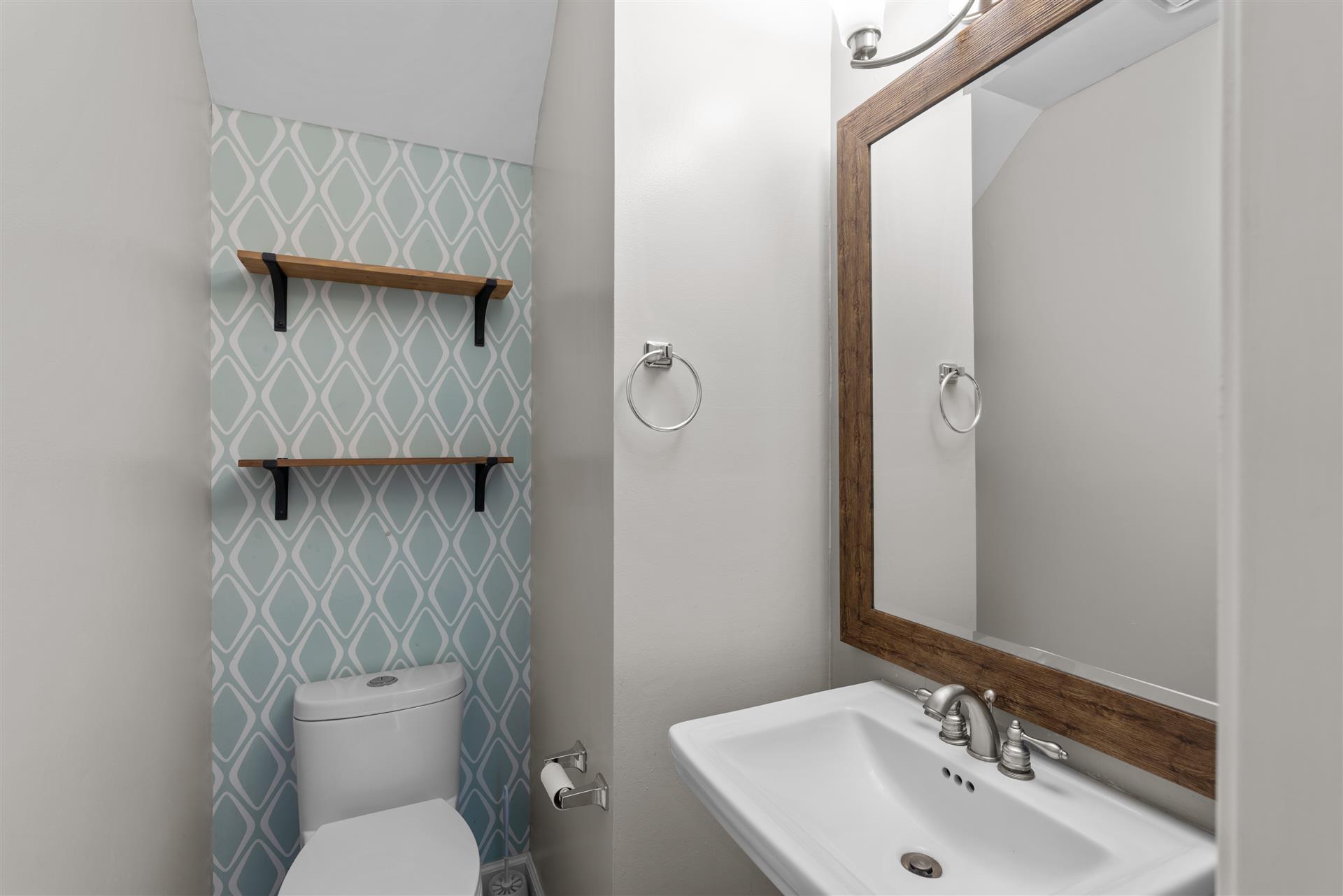 1710 Persimmon Road Cedar Park, TX 78613 - Photo 6 of 33 A thoughtfully designed downstairs half bathroom is ideally located off the kitchen and family room.