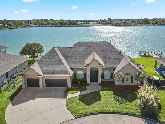 a aerial view of a house with swimming pool and a yard