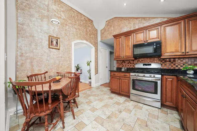 a kitchen with a stove a sink and a microwave