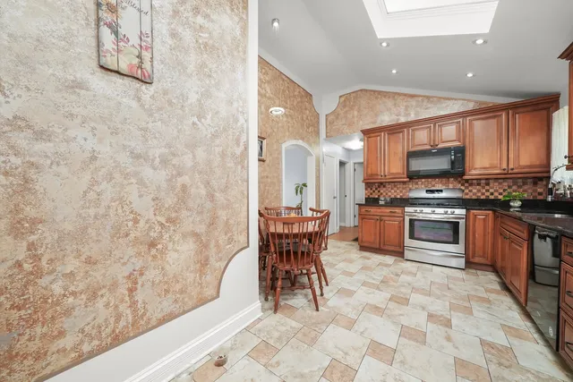 a kitchen with stainless steel appliances a stove a sink and a refrigerator