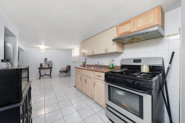 a kitchen with stainless steel appliances a stove a sink and a refrigerator