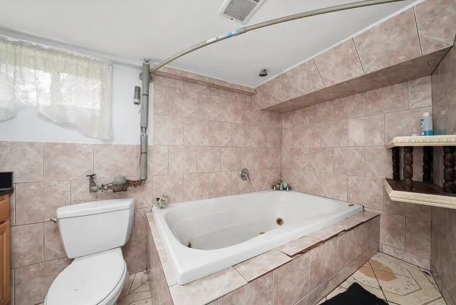 a white bath tub sitting next to a white toilet