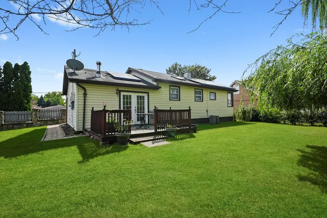 a view of a house with a backyard porch and sitting area