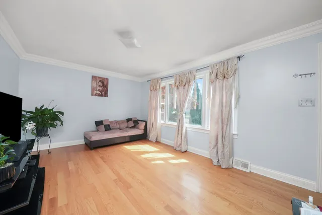 a bedroom with furniture and a flat screen tv