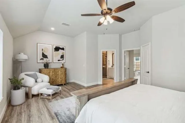 a spacious bedroom with a large bed and a large window