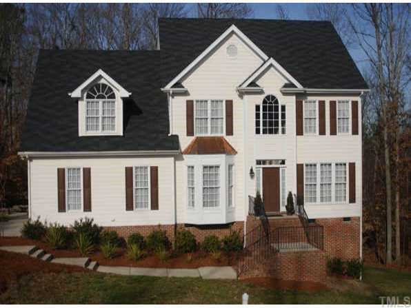 2909 Sunnystone Way Raleigh, NC 27613 - Photo 1 of 1 a view of a large white house with large windows next to a yard