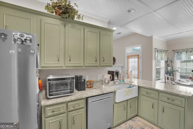a kitchen with a sink cabinets and appliances