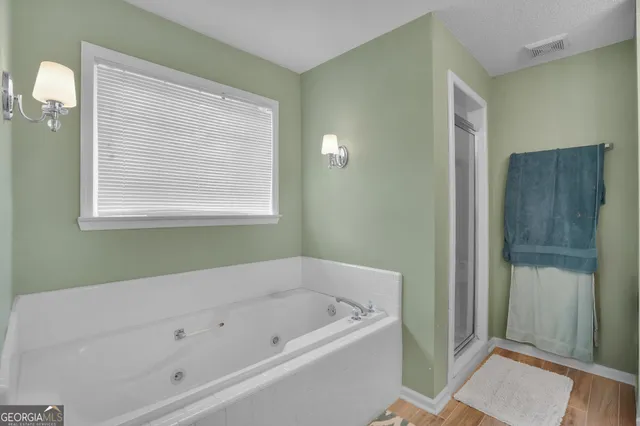 a bathroom with a bathtub and window