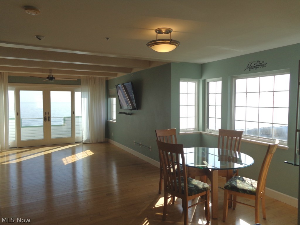 24 D Cedar Point Road Sandusky, OH 44870 - Photo 7 of 25 Living room/dining combination w/Lake Erie views, maple hard wood flooring, the attached TV stays, patio door to the outside composite deck.
