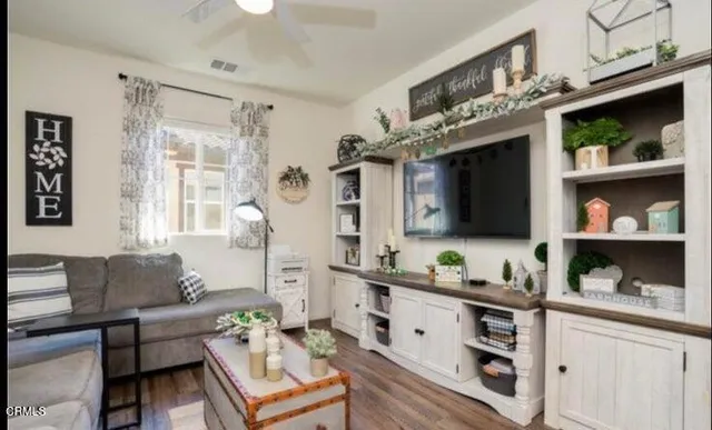 a living room with furniture and flat screen tv
