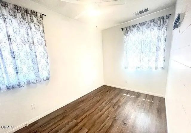 a view of a room with wooden floor and walls