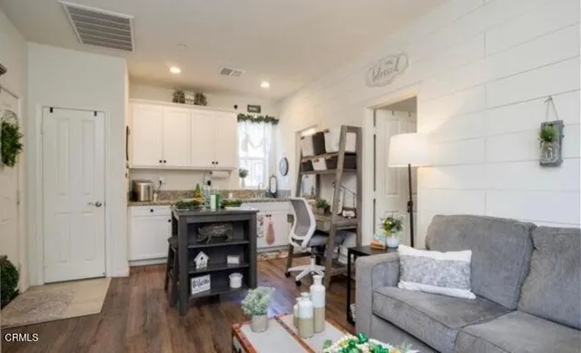 a living room with furniture and wooden floor