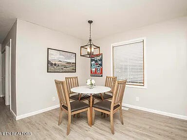 1339 Flatwood Road Sevierville, TN 37862 - Photo 13 of 26 a dining room with furniture window and wooden floor