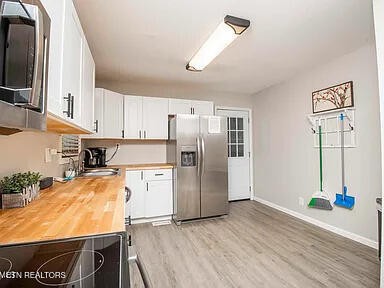 1339 Flatwood Road Sevierville, TN 37862 - Photo 14 of 26 a kitchen with stainless steel appliances granite countertop a refrigerator and a stove top oven