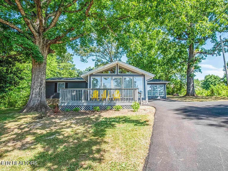 1339 Flatwood Road Sevierville, TN 37862 - Photo 2 of 26 a front view of house with yard entertaining space and trees around