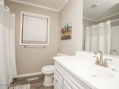 1339 Flatwood Road Sevierville, TN 37862 - Photo 22 of 26 a bathroom with a sink a toilet and a mirror