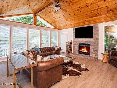 1339 Flatwood Road Sevierville, TN 37862 - Photo 8 of 26 a living room with furniture a large window and a fireplace