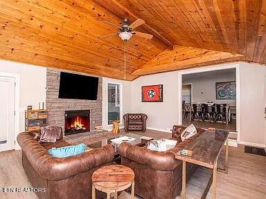 1339 Flatwood Road Sevierville, TN 37862 - Photo 9 of 26 a living room with furniture a flat screen tv and a fireplace