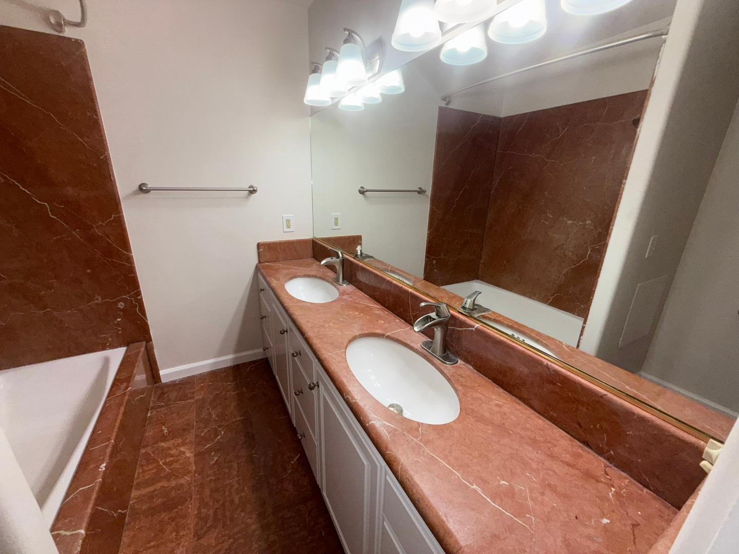 11585 McCarthy Road Carmel Valley, CA 93924 - Photo 31 of 52 a bathroom with a granite countertop sink toilet and a mirror