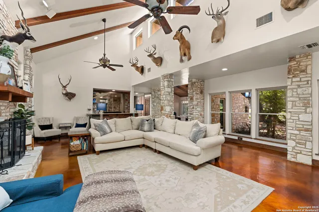 a dining hall with stainless steel appliances granite countertop a table and chairs with wooden floor