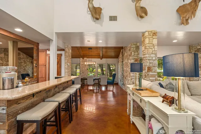 a dining room with furniture a chandelier and window