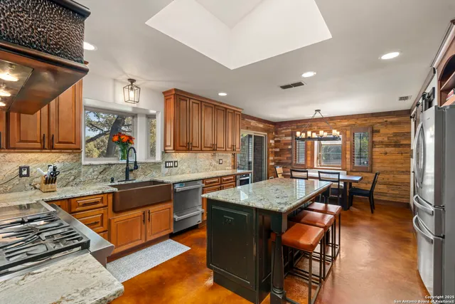 a kitchen with stainless steel appliances granite countertop a stove and a sink