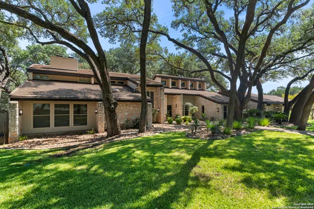 a view of a house with sitting area and garden