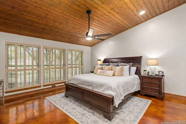 a bedroom with a large bed and a window