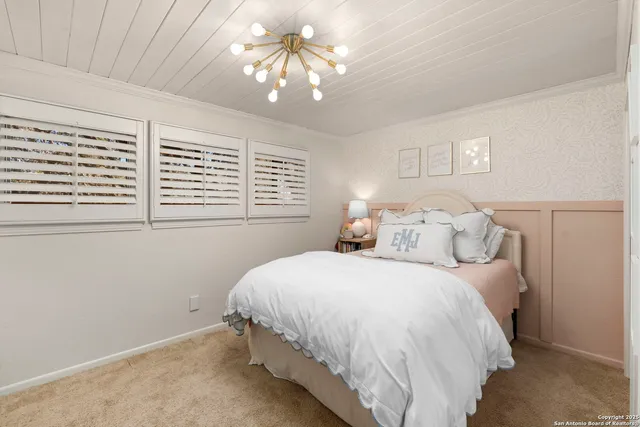 a front view of a house with a garden and trees