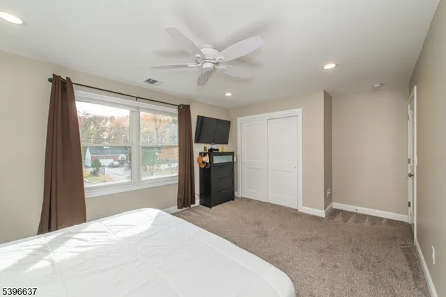 a bedroom with a large bed and a large window