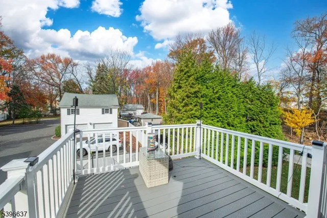 a view of a deck with furniture and trees around