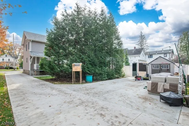 a view of a house with a yard and pathway