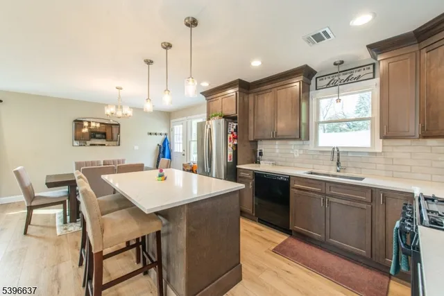 a large kitchen with a table and chairs