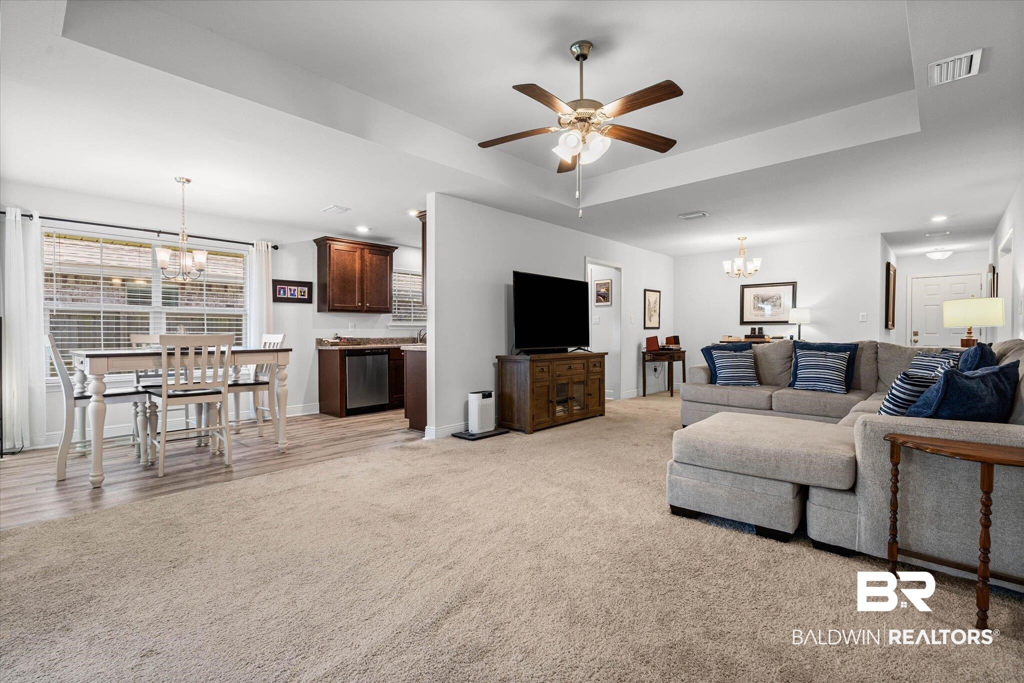 22420 Respite Lane Foley, AL 36535 - Photo 4 of 35 Open-concept living space featuring a tray ceiling with a ceiling fan, recessed lighting, and light-toned carpeting