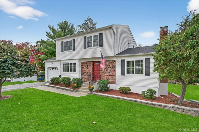 a front view of a house with a garden and plants