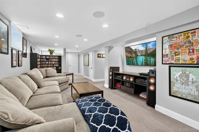 a living room with furniture and a book shelf