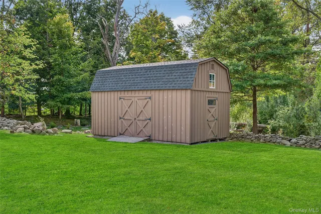 a backyard of a house with table and chairs