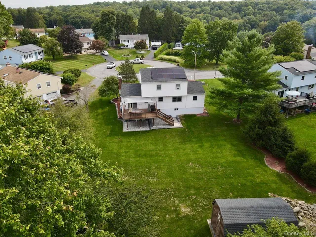 a view of house with backyard and garden