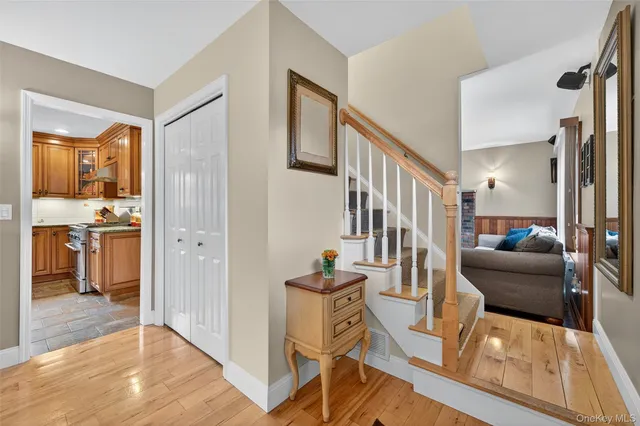 a view of a hallway with workspace and wooden floor