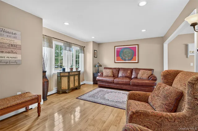 a living room with furniture and painting on the wall