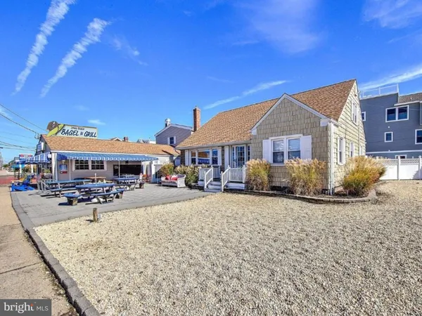 a front view of a house with yard porch and sitting area