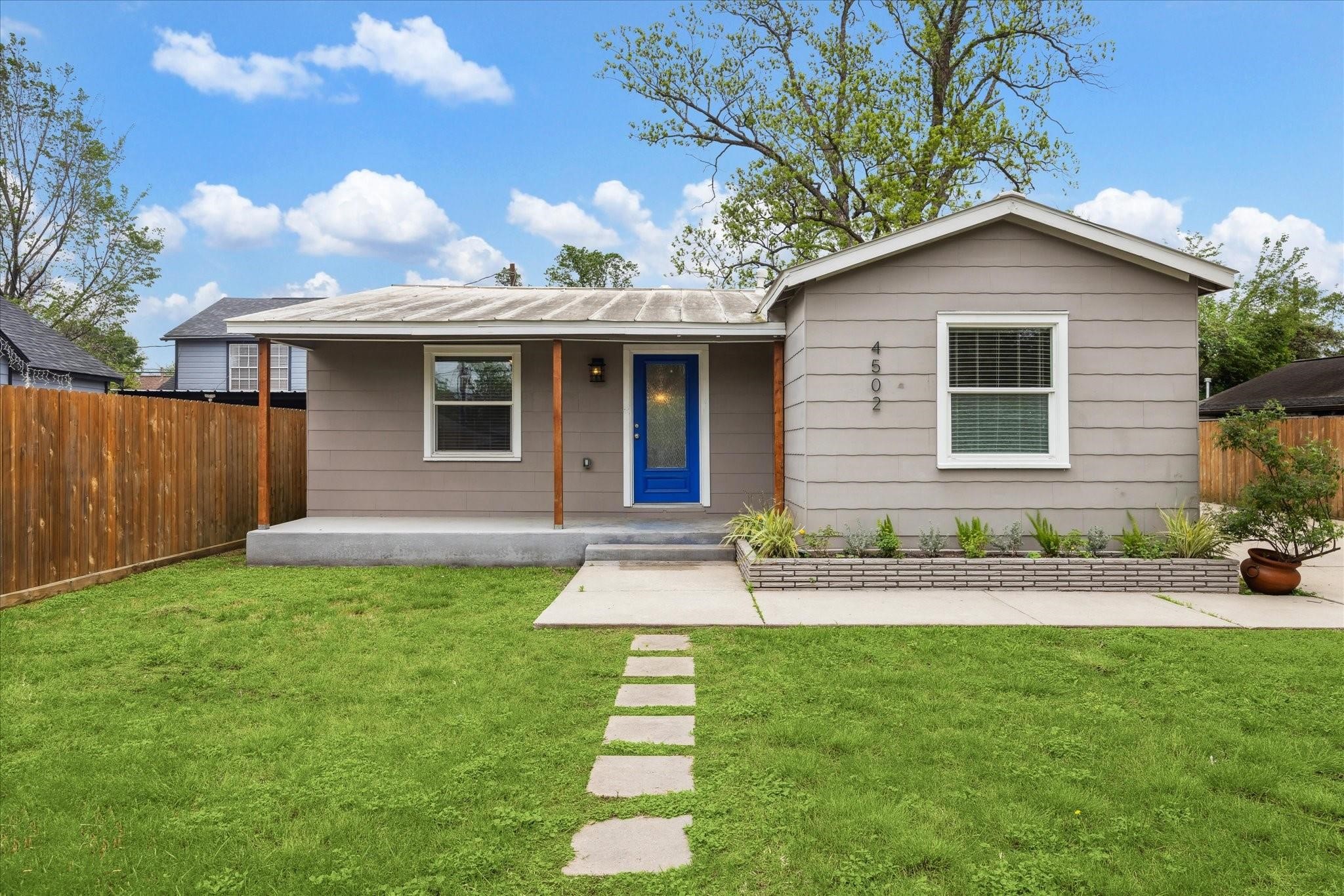 4502 Hain Street Houston, TX 77009 - Photo 2 of 16 a front view of a house with a yard