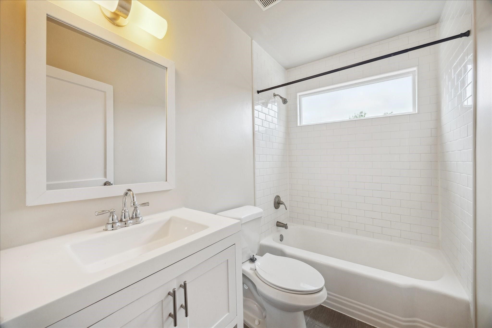 4502 Hain Street Houston, TX 77009 - Photo 9 of 16 a bathroom with a sink a toilet and a bathtub