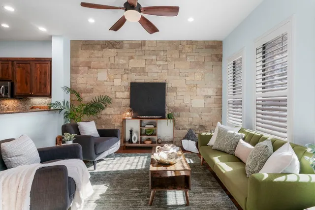 a living room with furniture wooden floor and a fireplace