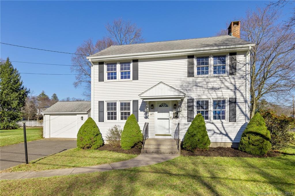 67 Brent Road Manchester, CT 06042 - Photo 1 of 1 a view of a white house with large windows and a small yard