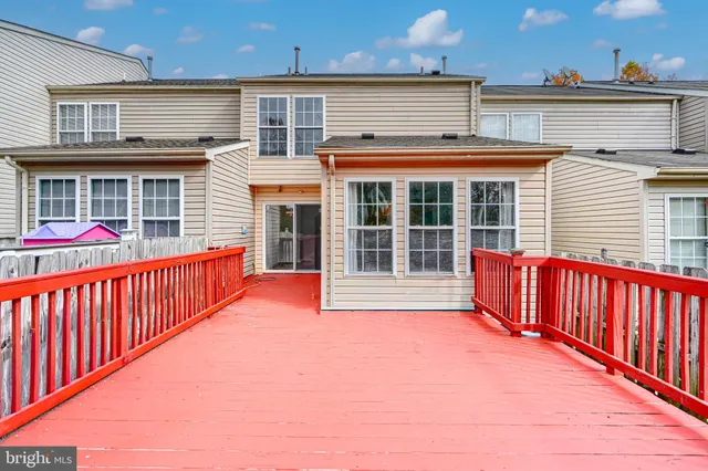 a view of a house with wooden deck