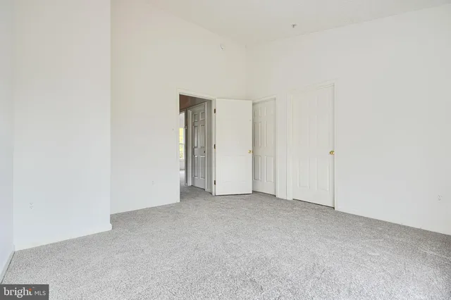 an empty room with windows and entrance